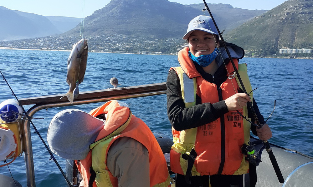 Children learning to fish on a family-friendly boat trip